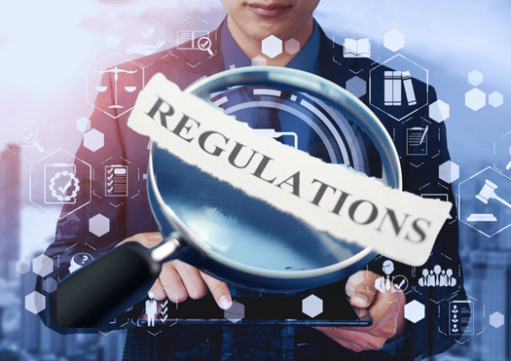 Businessman analyzing digital interface with a magnifying glass focusing on the word 'Regulations', representing betting laws and regulations in Europe.